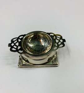 Silver Plate: Silver plated tea strainer in stand