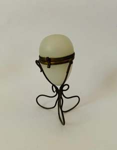Ornate Victorian milk glass egg in brass wire stand jewellery holder