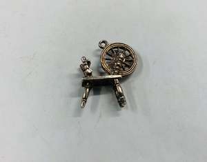 Jewellery: Silver spinning wheel charm