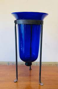 Large cobalt blue glass bell vase in a metal holder
