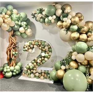 Jungle themed balloon garland and balloon mosaic number in sand and eucalyptus