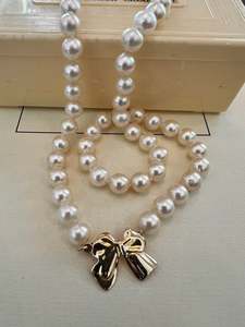Necklaces And Pendants: Pearl Necklace with Bow clasp in 9ct gold.