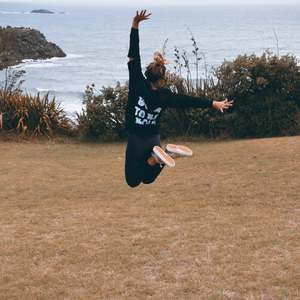 Kate jumps for joy wearing Bold's Born to be Bold Sequin hoodie in New Plymouth