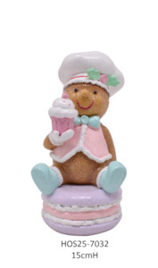 Pastel Gingerbread Sitting on a Macaroon holding a Cupcake