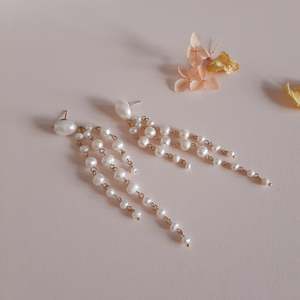 Cascading Cool: Linelle - freshwater pearls oval stud and tapered multi cascading earrings
