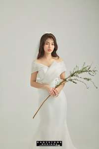 Elegant Off-Shoulder Wedding Dress with Wrap Detail and Bow Accent