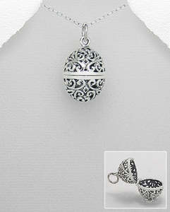 Lockets: Barrel shaped filigree locket on silver chain
