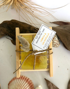 Products: Lemon & Calendula Petals on a wooden soap dish Eco Savvy