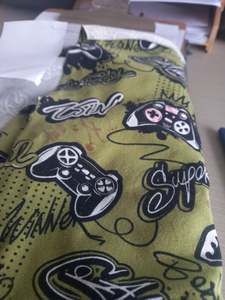Video games on Olive - Cotton Spandex - 1 metre remnant - print mark on fabric