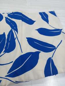 Woven: Neon Blue Leaves on white background 100% Linen - 1 metre remnant