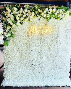 White Flower Wall with corner flower arrangement