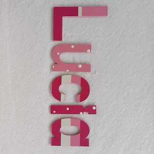 8 Names Suitable For Doors: Lucia - small letters suitable for a door.