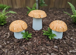Garden Decor Pick Up Only: Set of 3 pastel orange concrete mushrooms.