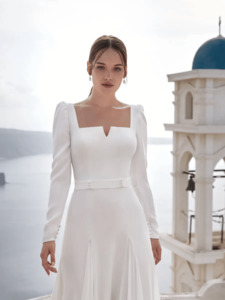 Products: Minimalist flared wedding dress in ecological crepe with blouson sleeves and geometric neckline