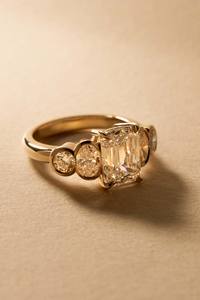 Five Stone Emerald Cut Centre with Bezel Set Diamond Accents