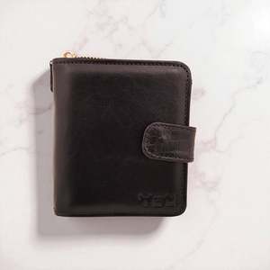Woman’s Genuine Leather Button Tab Zip Around Wallet - Black