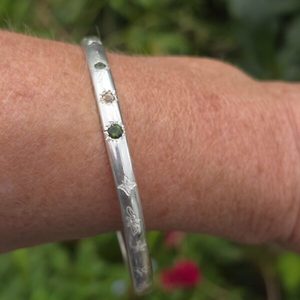 Products: Shine brightly bangle, green sapphire and imperial topaz in a 5mm x 3mm elliptical sterling silver. internal diameter 64.5mm. - Penelope Barnhill Jewellery