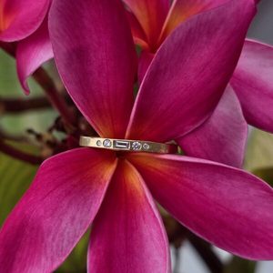 Products: Tiara Ring. 18ct yellow gold, 1x F VS 3.1x2mm baguette, 2x 1.8mm, 1.2mm F SI diamonds. Size 0 - Penelope Barnhill Jewellery