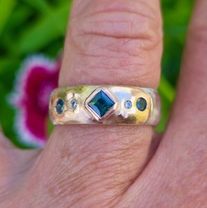 Products: Eclipse ring. 9ct and 18ct red and pink gold, silver, green sapphires and diamonds. - Penelope Barnhill Jewellery
