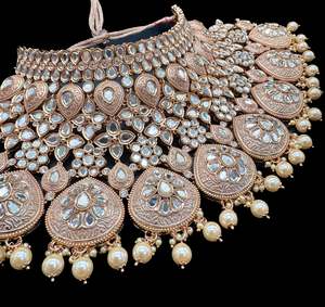 Bridal Necklaces Semi Bridal Necklaces: (video clip attached)Lite Golden base Original Kundan Polki stones with Meenkari & Pearls work Bridal necklace with beautiful Jhumka, tikka , 2 Rings NOTE:- original Kundan Polki stones not fake plastic stones)