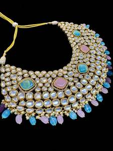 Bridal Necklaces Semi Bridal Necklaces: (video clip attached)Pastel Pink & Blue Beautiful uncut Kundan stones with pearls studded very Heavy work necklace with beautiful Jhumka Passa, Sheesh Patti attached to tikka ,Hand Jewellery and Nath NOTE:- original Kundan stones not fake plastic stones)