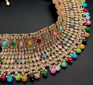 Bridal Necklaces Semi Bridal Necklaces: (video clip attached )Multicolor Beautiful and elegant look Original Polki stones with pearls studded very Heavy work necklace with beautiful bigger size earrings and Tikka Note :- original Polki stones not fake plastic stones )