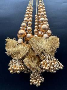 Beautiful golden design medium size lehnga latkans tessels (pair)