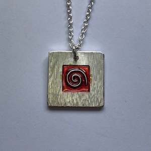 Koru pendant with red cloisonne enamel