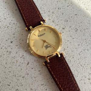 Burberrys Gold Lady Watch with Sculpted Loop Lugs and Champagne Dial 32mm Diameter