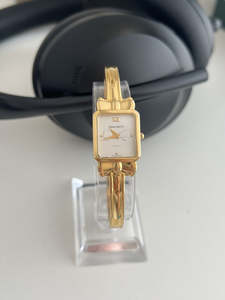 Nina Ricci Gold Tone Bow Bangle Watch