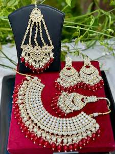 Pearl loaded necklace set with passa in Kundan in red colour