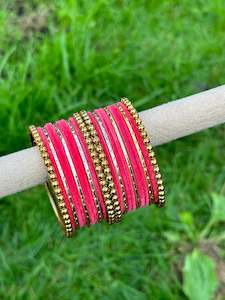 Carrot pink velvet bangles set with golden beaded kangan’s
