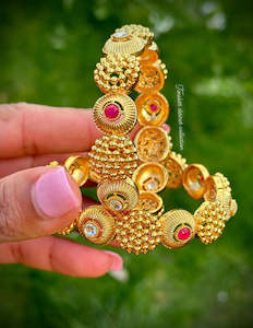 Gold look kangan with ruby stone