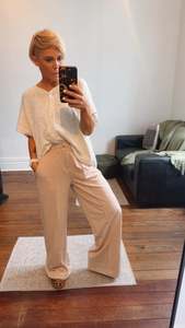 Refuge Beige Wide Leg Trousers With Tuck Detail Front